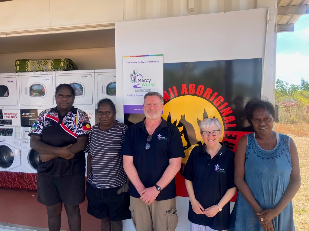 Borroloola community members with Mercy Works Head of Programs Andrew Lowry and Executive Director Sally Bradley RSM in front of the Borroloola Remote Laundry, Northern Territory.